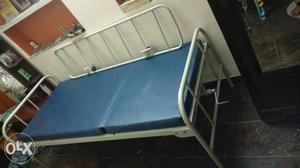 Medical adjustable cot: White Metal Framed Bed With Blue
