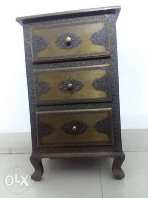 This is an antique look side table with three