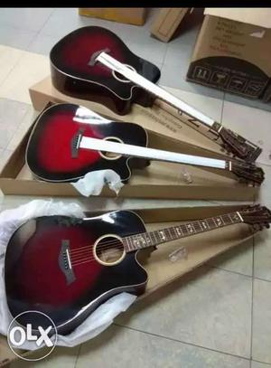Three Red-and-black Single-cutaway Guitars With Boxes
