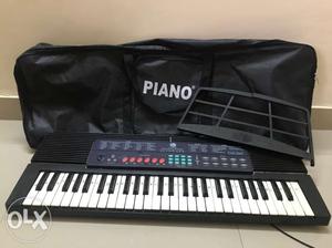 Black Electronic Keyboard And Black Piano Duffel Bag
