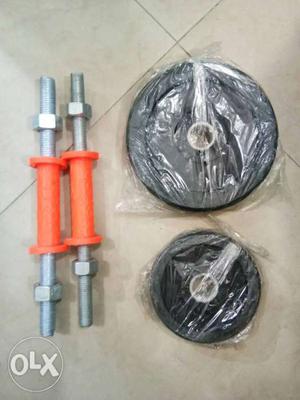 Two Black Weight Plates And Two Dumbbell Rods