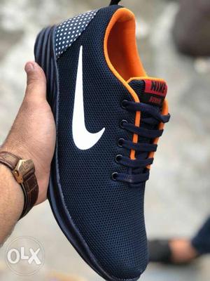 Unpaired Orange And Black Nike Low-top Sneaker