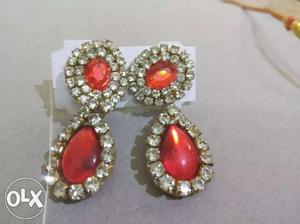 Pair Of Gold-colored Earrings With Clear And Red Gemstones