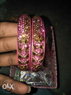 Two Gold-colored Pink Gemstone Encrusted Bangles