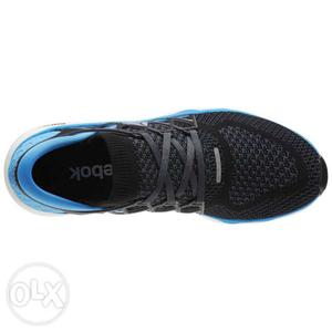 Unpaired Black And Blue Reebok Running Shoe