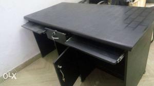 An office table with 2 computer shelf, 2 double