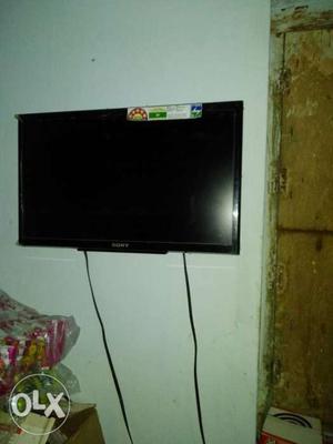 Black Flat Screen TV With Stand