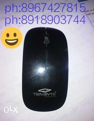 Black Wireless Mouse With Text Overlay