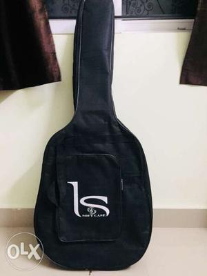 Black acoustic guitar of good quality with cover- 3 yrs old