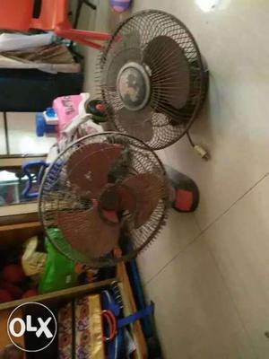Two Black And Red Wall-mount Electric Fans