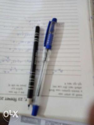 Two Blue And Black Ball Point Pens