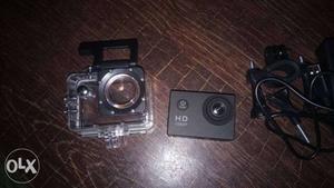 Black Action Camera On Brown Panel with water proof case