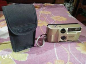 Brown Camera With Black Bag