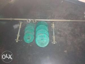 Gym equipments Green Weight Plates And Gray Rod