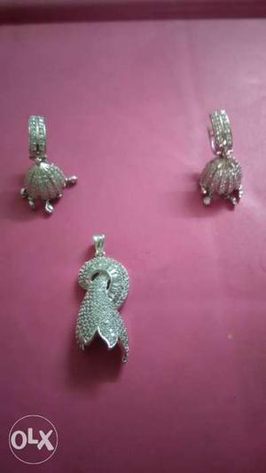Pairs Of Silver-colored Earrings And Pendant