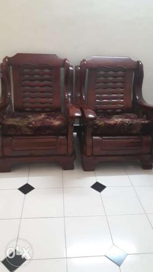 Three Brown Wooden Armchairs Inside Room