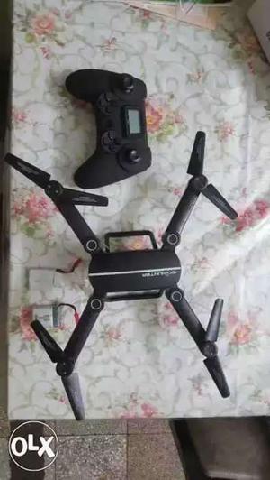 Black Quadcopter And Game Controller