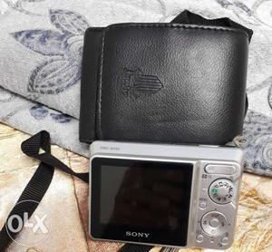 Gray Sony Digital Camera With Black Leather Case