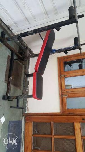 Black And Red Inline Bench Press with weightss and dumble