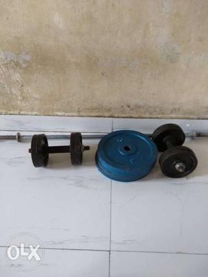 Blue Weight Plates And Black Dumbbells