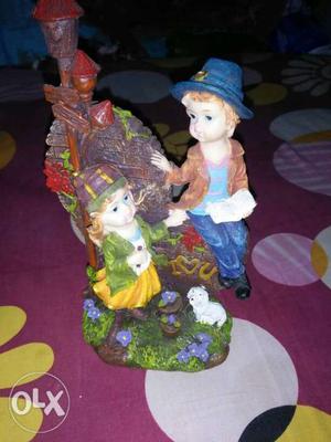 Boy And Girl Sitting Ceramic Figurine