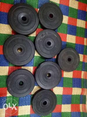 Four Black And Gray Barbell Plates