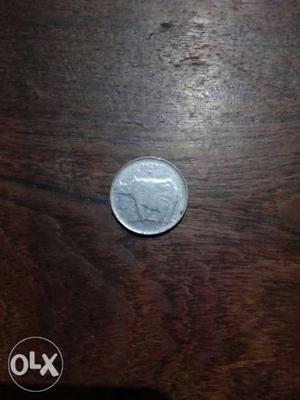 Round Silver-colored 25 Indian Paise Coin