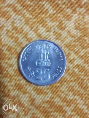 Round Silver-colored Indian 25 Paise Coin