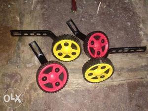 Two Pairs Of Red And Yellow Caster Wheels