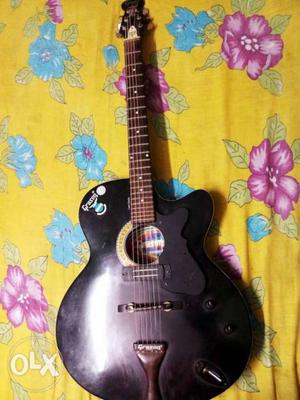 Black Single-cutaway Acoustic Guitar On Multicolored Floral