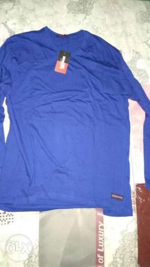 Blue Long-sleeved Shirt On Gray Surface