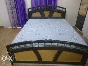 Wooden bed with mattresses.