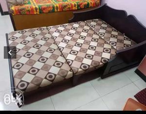 Brown Wooden Bed Frame With White And Black Bed Sheet