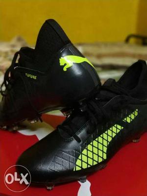 Pair Of Black-and-yellow Puma Cleat Shoes
