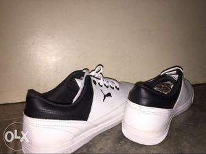 Pair Of White-and-black Puma sneakers