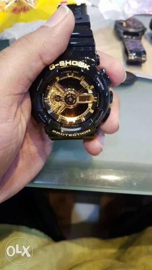 Round Black And Gold Chronograph Watch