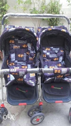 Two Black And Purple Car Seat Carriers