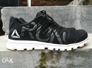Pair Of Black-and-white New Balance Sneakers