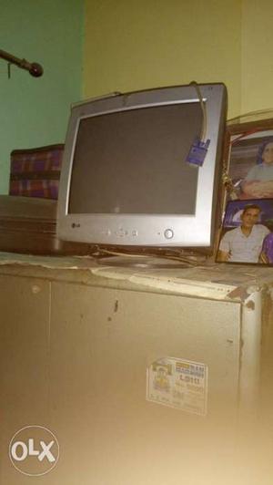 White CRT TV With Brown Wooden TV Hutch