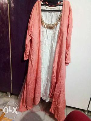 A pink colour shrug with a separate white kurti