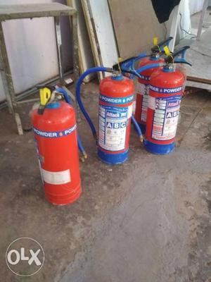 Four Red Fire Extinguishers