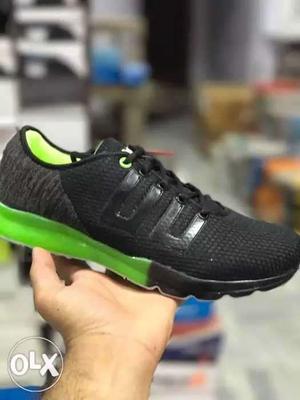 Unpaired Black And Green Running Shoe