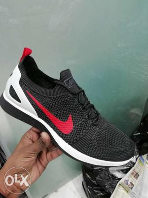 Unpaired Black, White, And Red Nike Running Shoe