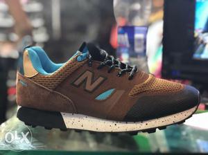 Unpaired Brown And Blue New Balance Running Shoe