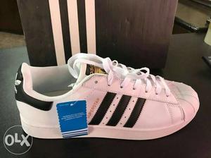 Unpaired White And Black Adidas Superstar