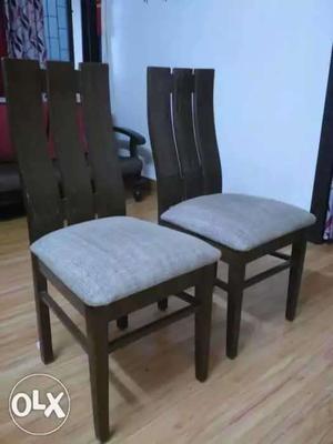 2 wooden chairs with comfortable lower back rest