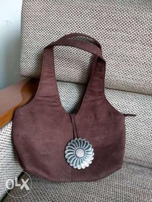 Velvet evening bag with metal flower