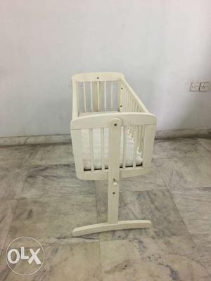 White Wooden Rocking Chair With White Pad