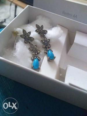 Pair Of Silver-colored Earrings With Teal Gemstone