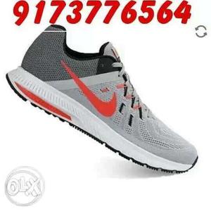 Unpaired Gray And Black Nike Sneaker With Text Overlay